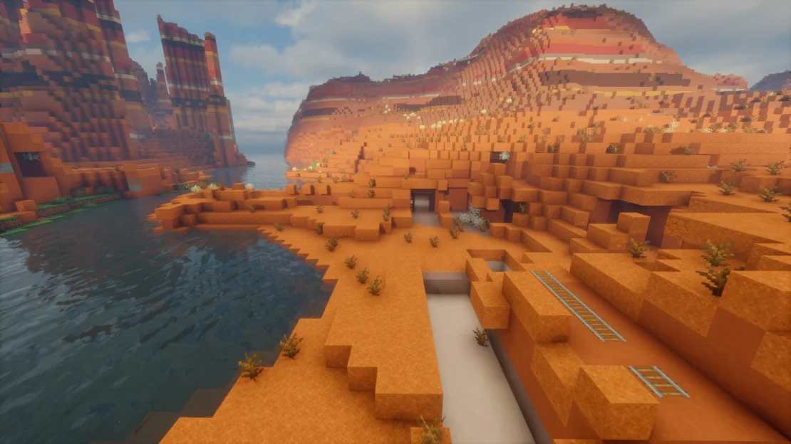 Spawn in a Badlands biome with an exposed mineshaft right at the surface in Minecraft