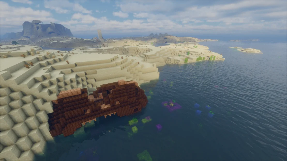 Minecraft shipwreck near coral reef with village and ruined portal nearby